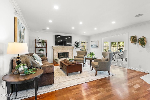 living room featuring crown molding and light wood-type flooring