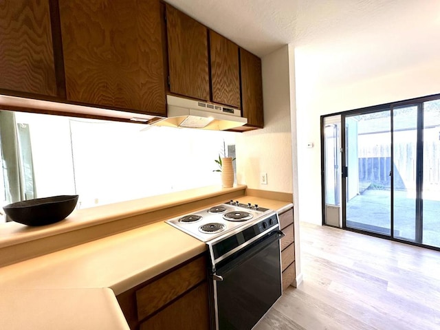 kitchen featuring electric stove and light hardwood / wood-style flooring