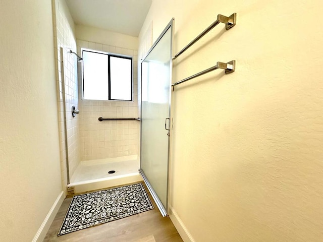 bathroom featuring hardwood / wood-style floors and walk in shower