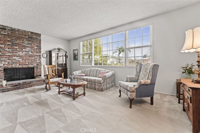 living area with a textured ceiling, a brick fireplace, and light colored carpet