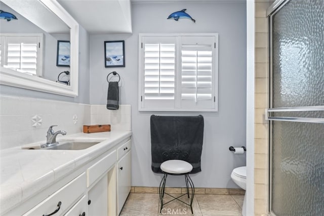 full bathroom with tile patterned flooring, a shower stall, toilet, and vanity