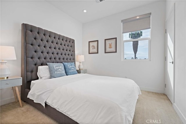 bedroom featuring light colored carpet