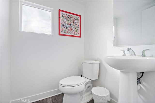 bathroom featuring sink, hardwood / wood-style floors, and toilet