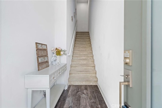 stairs featuring hardwood / wood-style floors