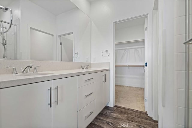 bathroom with vanity, hardwood / wood-style floors, and an enclosed shower