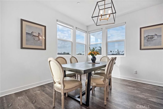 dining area featuring dark hardwood / wood-style floors and a chandelier