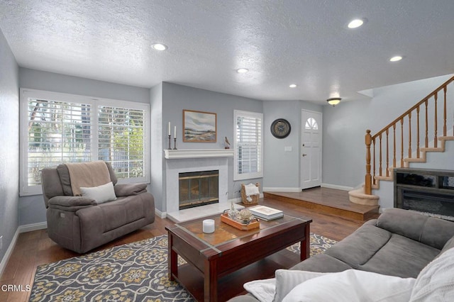 living room with dark hardwood / wood-style flooring and a textured ceiling