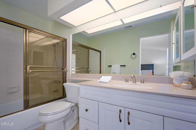 full bathroom featuring vanity, toilet, and combined bath / shower with glass door