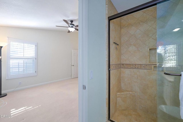 bathroom with walk in shower and ceiling fan