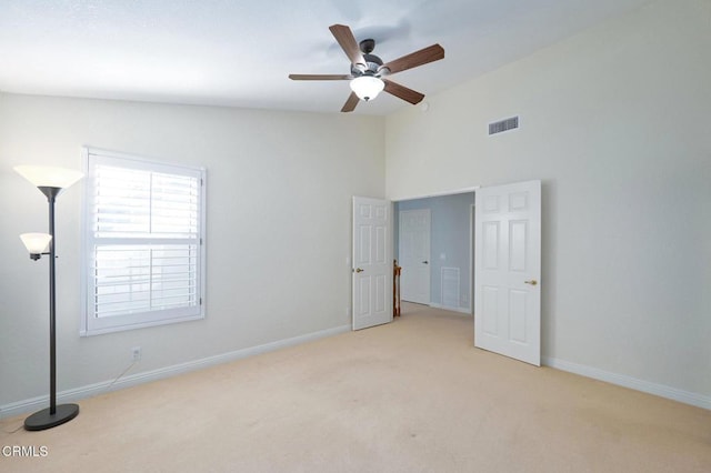 carpeted spare room with ceiling fan