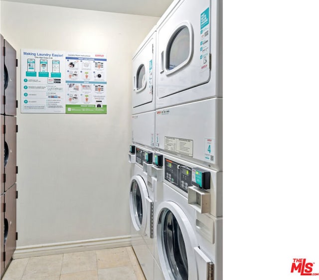 clothes washing area featuring light tile patterned flooring, stacked washer / dryer, and washer and clothes dryer