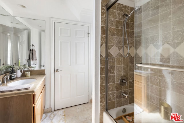 bathroom with vanity and shower / bath combination with glass door