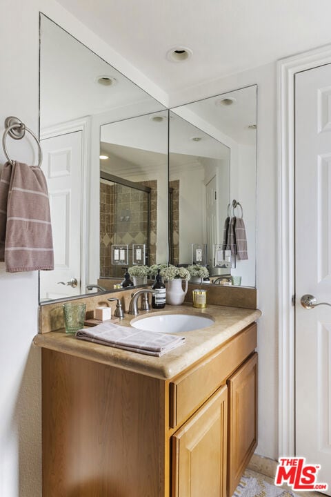 bathroom featuring vanity and an enclosed shower