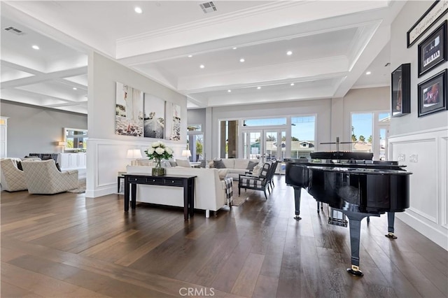 living room featuring ornamental molding, dark hardwood / wood-style floors, beam ceiling, and french doors