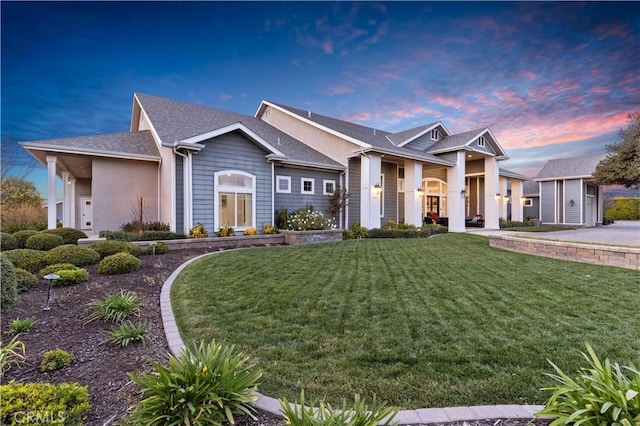 view of front facade with an outdoor structure and a lawn