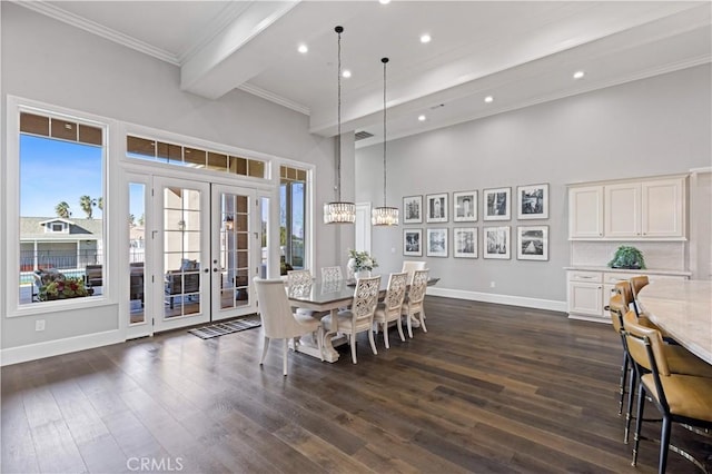 dining space featuring dark wood-type flooring, an inviting chandelier, and french doors