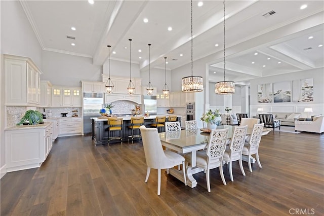 dining area featuring beamed ceiling, dark hardwood / wood-style flooring, a chandelier, and crown molding