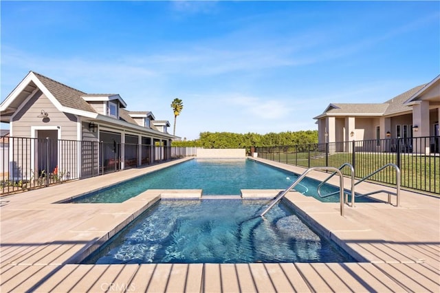 view of swimming pool with a patio area and an in ground hot tub