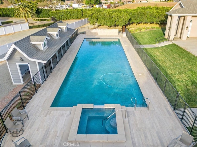 view of swimming pool with a yard and a patio area