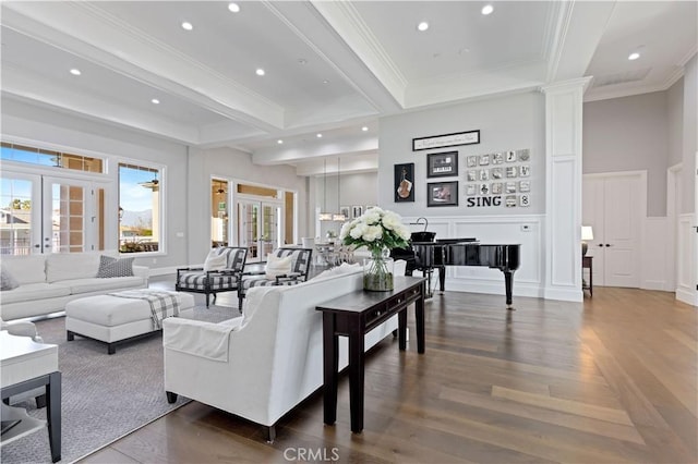 living room with crown molding, french doors, beamed ceiling, and ornate columns