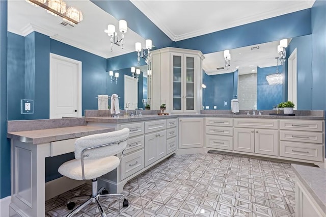 bathroom with ornamental molding, vanity, and a chandelier