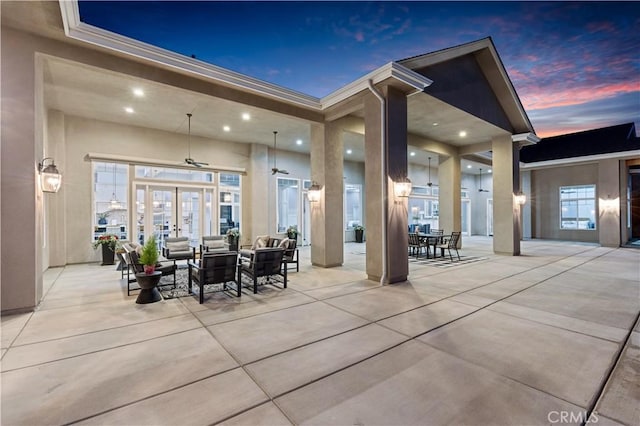 patio terrace at dusk featuring french doors