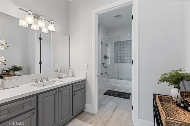 bathroom with vanity and combined bath / shower with glass door