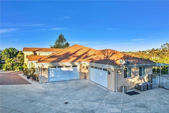 view of front of property with cooling unit and a garage