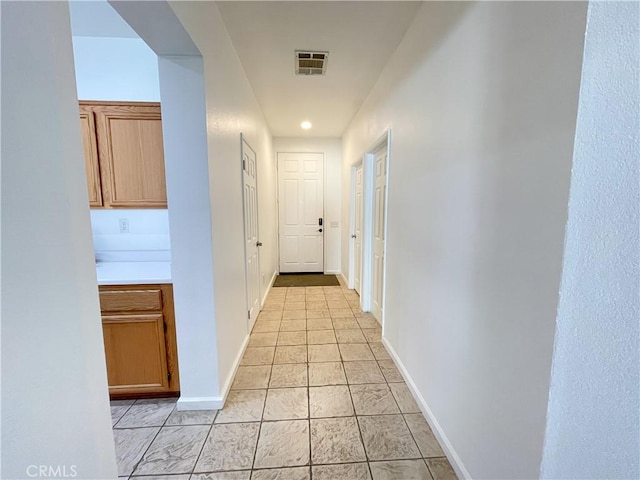 corridor with light tile patterned flooring