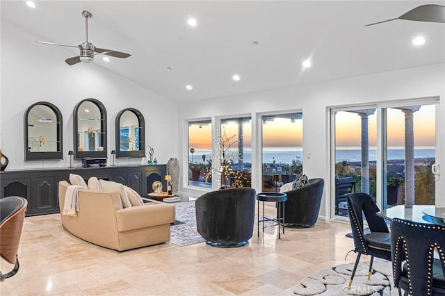 living room featuring ceiling fan, lofted ceiling, and a wealth of natural light