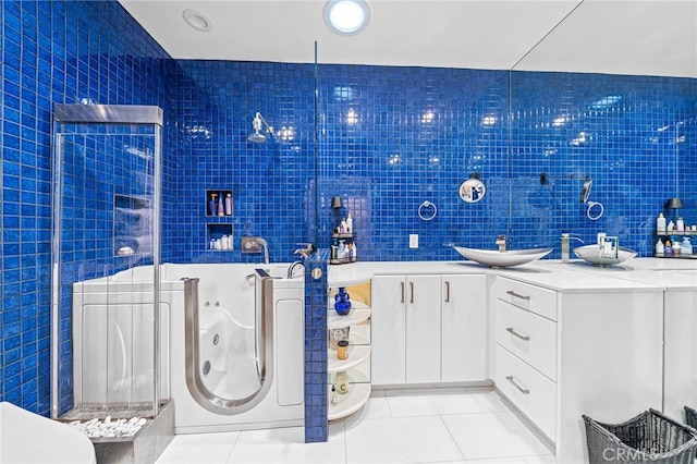 bathroom featuring vanity, tile walls, tile patterned floors, and walk in shower