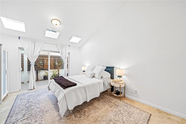 bedroom with lofted ceiling with skylight and access to outside