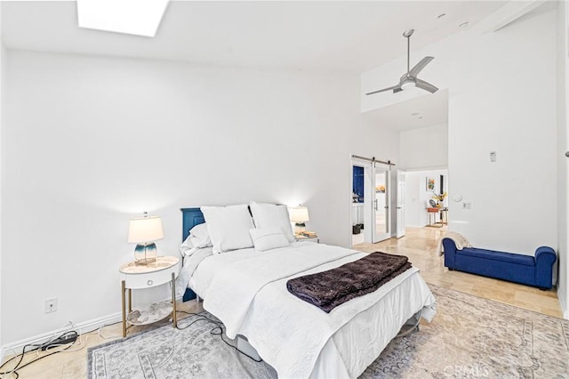 bedroom featuring a barn door and a skylight