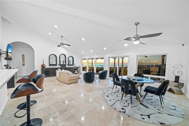 dining space featuring lofted ceiling with beams and ceiling fan