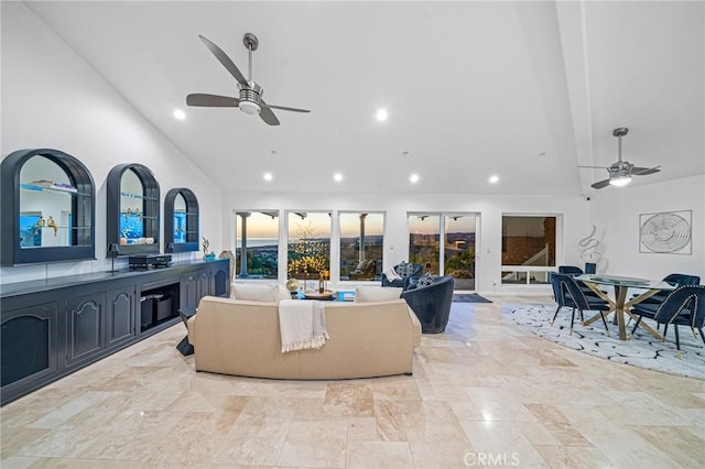 living room featuring ceiling fan and high vaulted ceiling