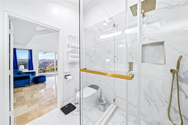 bathroom featuring a shower with door and crown molding