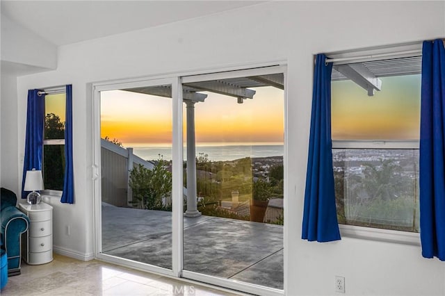 doorway to outside with a water view