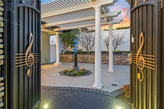 patio terrace at dusk with a pergola