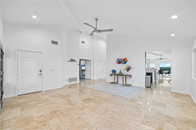 foyer entrance featuring lofted ceiling with beams and ceiling fan