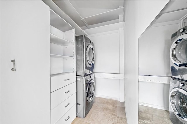 washroom featuring stacked washer / drying machine