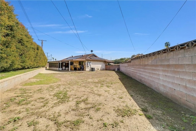 back of property with a fenced backyard