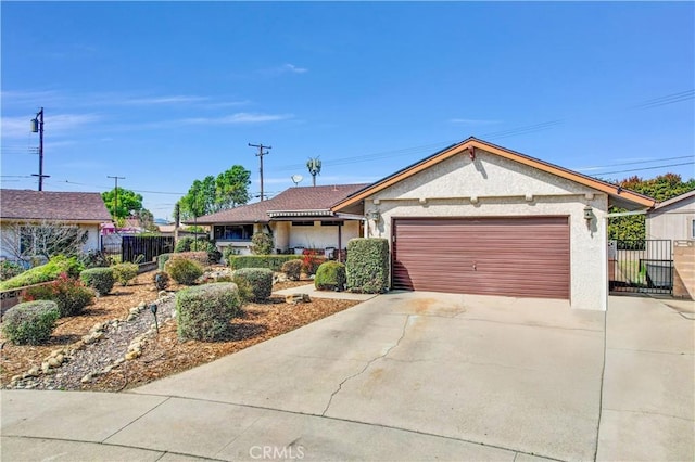 ranch-style house featuring stucco siding, driveway, an attached garage, and fence