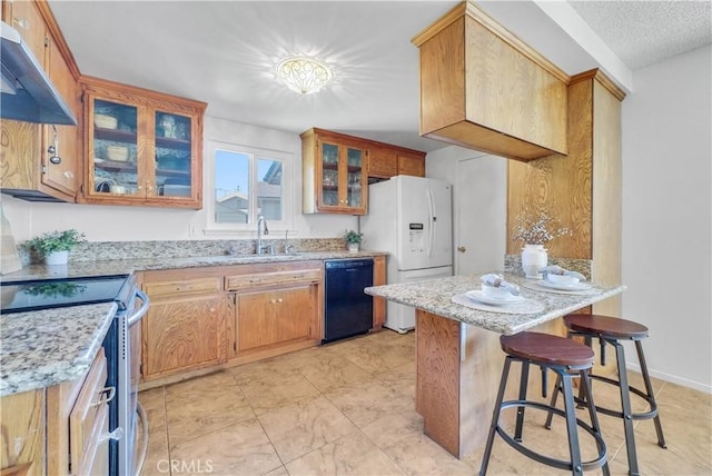 kitchen featuring under cabinet range hood, dishwasher, a kitchen bar, a peninsula, and white fridge with ice dispenser