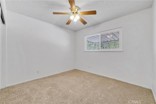 empty room featuring baseboards, carpet floors, a textured ceiling, and ceiling fan