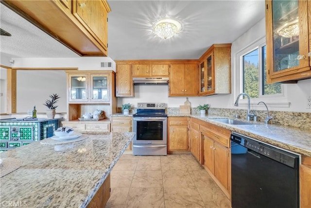 kitchen with light stone countertops, under cabinet range hood, black dishwasher, electric range, and a sink