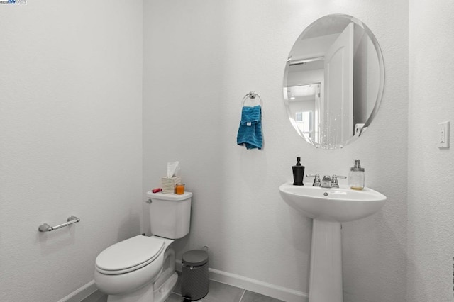 bathroom featuring sink, tile patterned floors, and toilet