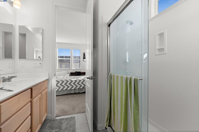 bathroom featuring vanity, a shower with door, and tile patterned floors