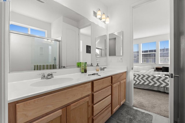 bathroom featuring vanity, tile patterned floors, and a shower with shower door