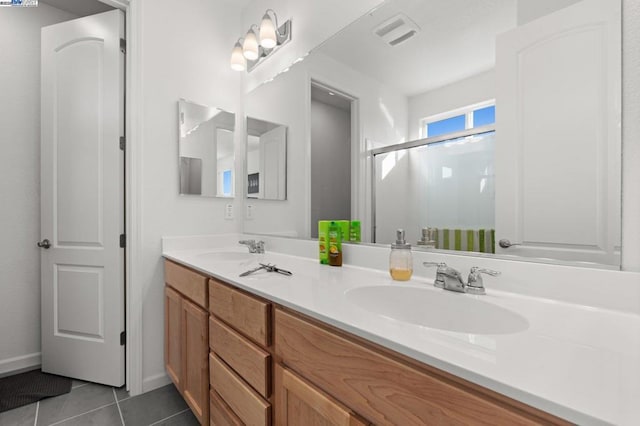 bathroom featuring vanity, tile patterned floors, and walk in shower