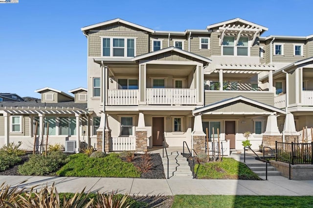 view of front of property with a balcony and a pergola